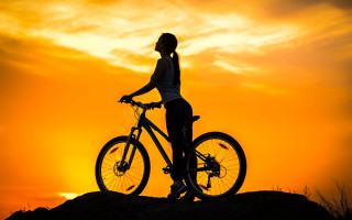 Woman hill bike sunset sky - a beautiful sky free wallpaper