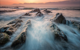 Sunset beach waves rocks clouds - a long exposure of a sunset over a rocky beach free wallpaper
