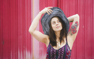 Woman hat red wall portrait - a red wall behind her free wallpaper