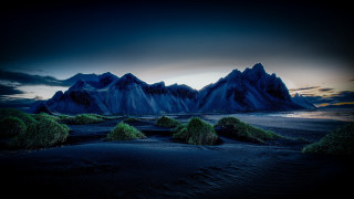 Mountain range grass sand water - a dark sky free wallpaper