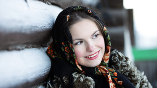 Woman smiling scarf snow background - the ground behind her free wallpaper