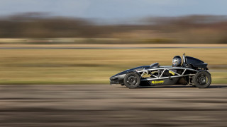 Black racecar driving road grass - dave allsop free wallpaper