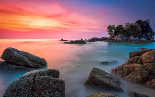 Colorful sunset rocky beach island - a small island in the distance free wallpaper for desktop