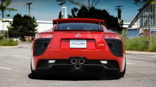 Red sports car parking lot 58 - a building and trees free wallpaper