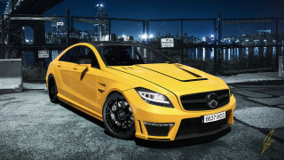 Yellow sports car night cityscape - a city skyline in the background free wallpaper