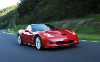 Red sports car driving forest 8 - a forest in the background free wallpaper for desktop