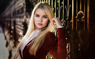 Blonde woman fence serious portrait - against free wallpaper for desktop