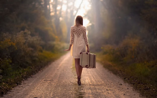 Woman walking dirt road suitcase 2 - dirk crabeth free wallpaper