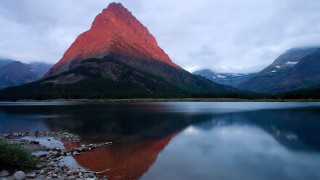 Mountain range reflection lake shore - rock and grass free wallpaper