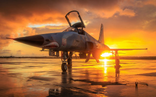 Fighter jet sunset clouds backlit 2 - top of an airport tarmac free wallpaper