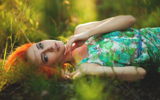 Woman lying grass outdoors blurry - the ground in a field of grass free wallpaper