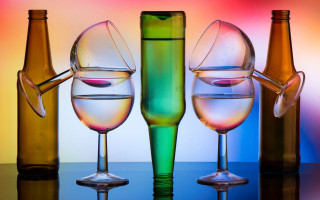 Wine glasses bottles multicolored background - background behind them free wallpaper