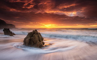Sunset beach waves rocks large - a large rock free wallpaper