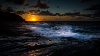 Sunset ocean waves rocks cityscape 2 - a sunset over the ocean free wallpaper
