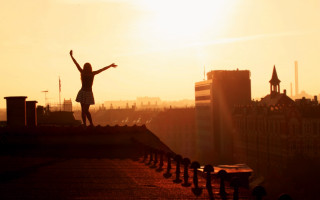 Woman roof outstretched sunrise cityscape - a roof free wallpaper