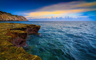 Cliff water sunset clouds beach - a cliff face free wallpaper