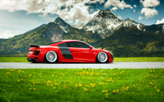 Red sports car mountain landscape - flower and grass free wallpaper