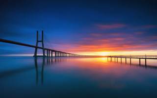 Sunset bridge water sky mountains - a long bridge free wallpaper