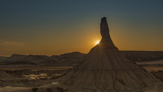 Desert rock formation sunset person - rim light free wallpaper