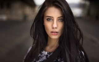 Woman longhair streetcorner serious portrait - her face and shoulder free wallpaper