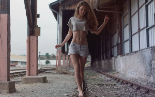 Woman shorts shirt traintrack city - a train track in the background free wallpaper