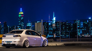 White car night city skyline - a city skyline in the background free wallpaper