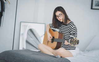 Woman playing guitar bed room - a white wall free wallpaper for desktop