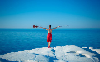 Woman standing on rock arms - surreal photography free wallpaper