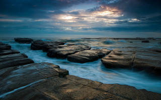 Rocky beach waves cloudy sky 2 - against the rock free wallpaper
