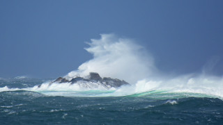 Large wave rock ocean blue - a rock in the ocean free wallpaper