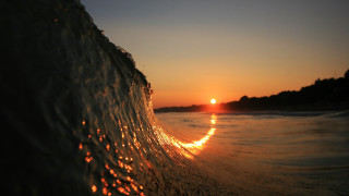 Wave sunset beach city lights - the sun setting behind free wallpaper