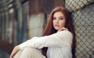 Woman fence hands on knees - a woman leaning against a fence free wallpaper