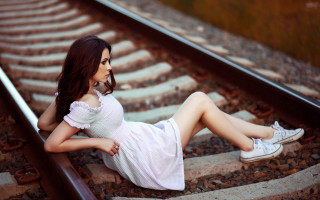 Woman sitting train track photorealistic - her shoe free wallpaper