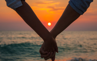 Beach sunset holding hands romantic - the background and the ocean in the foreground free wallpaper