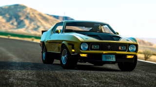 Yellow black car mountain road - a mountain range in the distance free wallpaper
