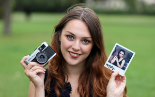 Woman holding polaroids camera portrait - anna findlay free wallpaper