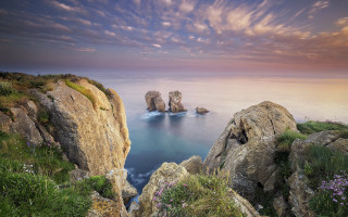 Rocky cliff water clouds landscape - a sky free wallpaper for desktop