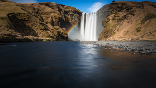 Waterfall rainbow river rocks grass - a river below free wallpaper