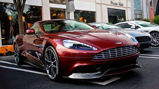Red car parked next to 2 - a red car free wallpaper
