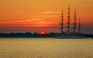 Large boat sunset water mountains - a large boat free wallpaper