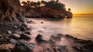 Rocky beach small island sunset - a small island in the distance free wallpaper