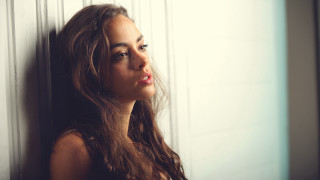 Woman leaning wall serious portrait 5 - long hair leaning against a wall free wallpaper