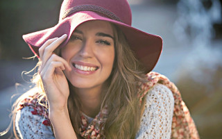 Woman smiling cowboyhat portrait blurry - her cheek free wallpaper