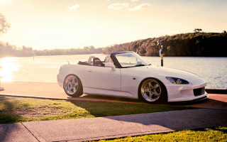 White sports car lake dock - a boat in the background free wallpaper for desktop