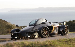Black gold car ocean mountains - spectacular free wallpaper