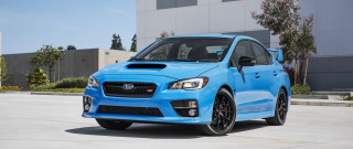 Blue subaru parking lot building - a building in the background free wallpaper for desktop