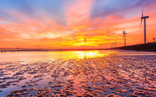 Sunset windmills colorful sky water - the background and a body of water free wallpaper