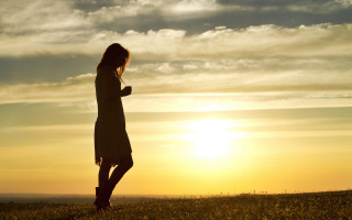 Woman sunset field cellphone mountains - top of a grass free wallpaper