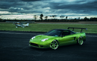 Green sports car runway plane - a plane in the background free wallpaper for desktop