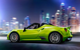 Green sports car night city - a city skyline in the background free wallpaper